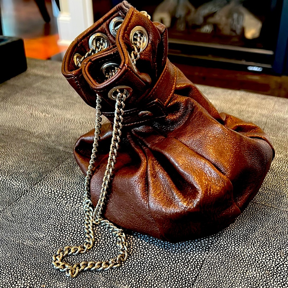 Argentinian designer Prune handbag. New without tags. Chain and button closure.
